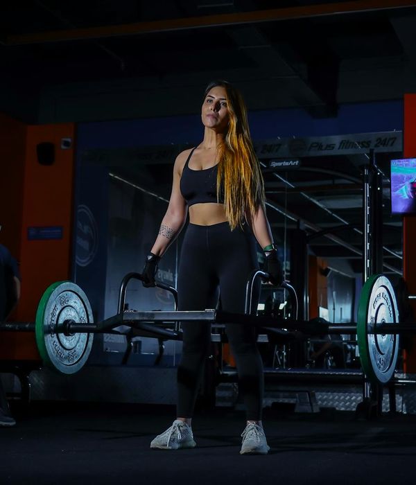 Athlete in a moment of concentration before a lift in a minimalist gym.